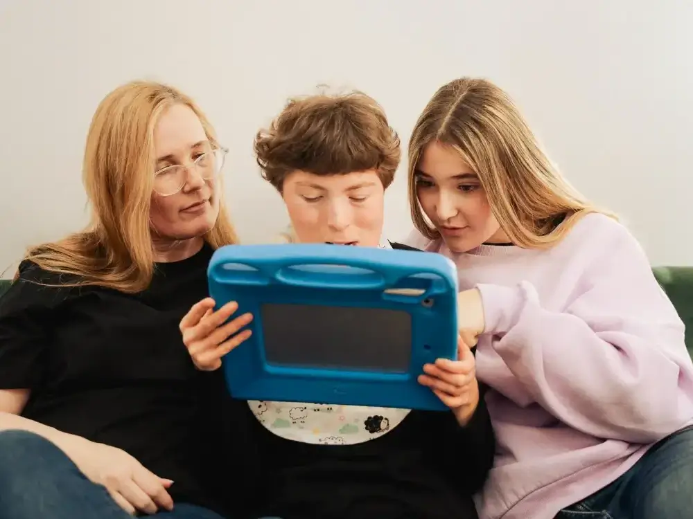 A mother and her two daughters use Independo and their talker.